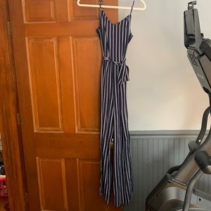Size M Morneault blue and white striped bootcut romper with slit on legs.